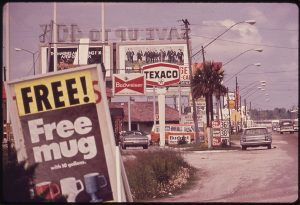 A main street with multiple billboards until the end of the street